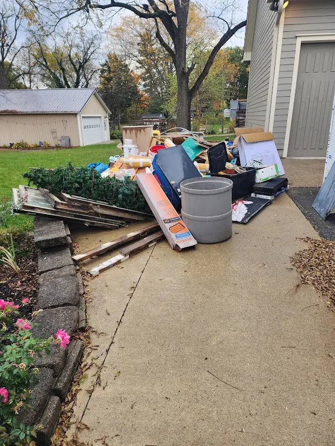 Dumpster being loaded with debris for Residential Dumpster Rental in Henrietta